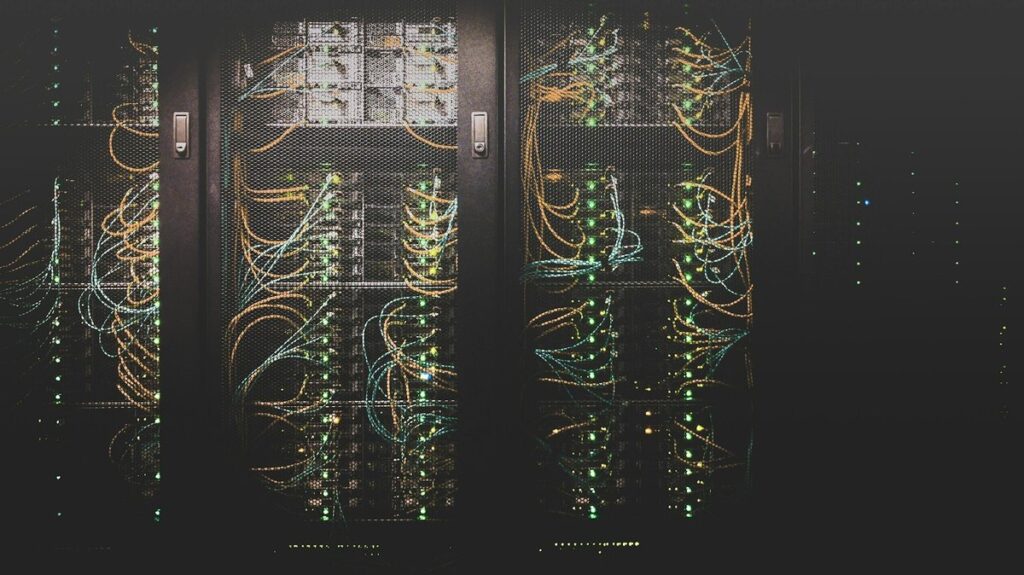 Server racks with network cables and status lights in a data center