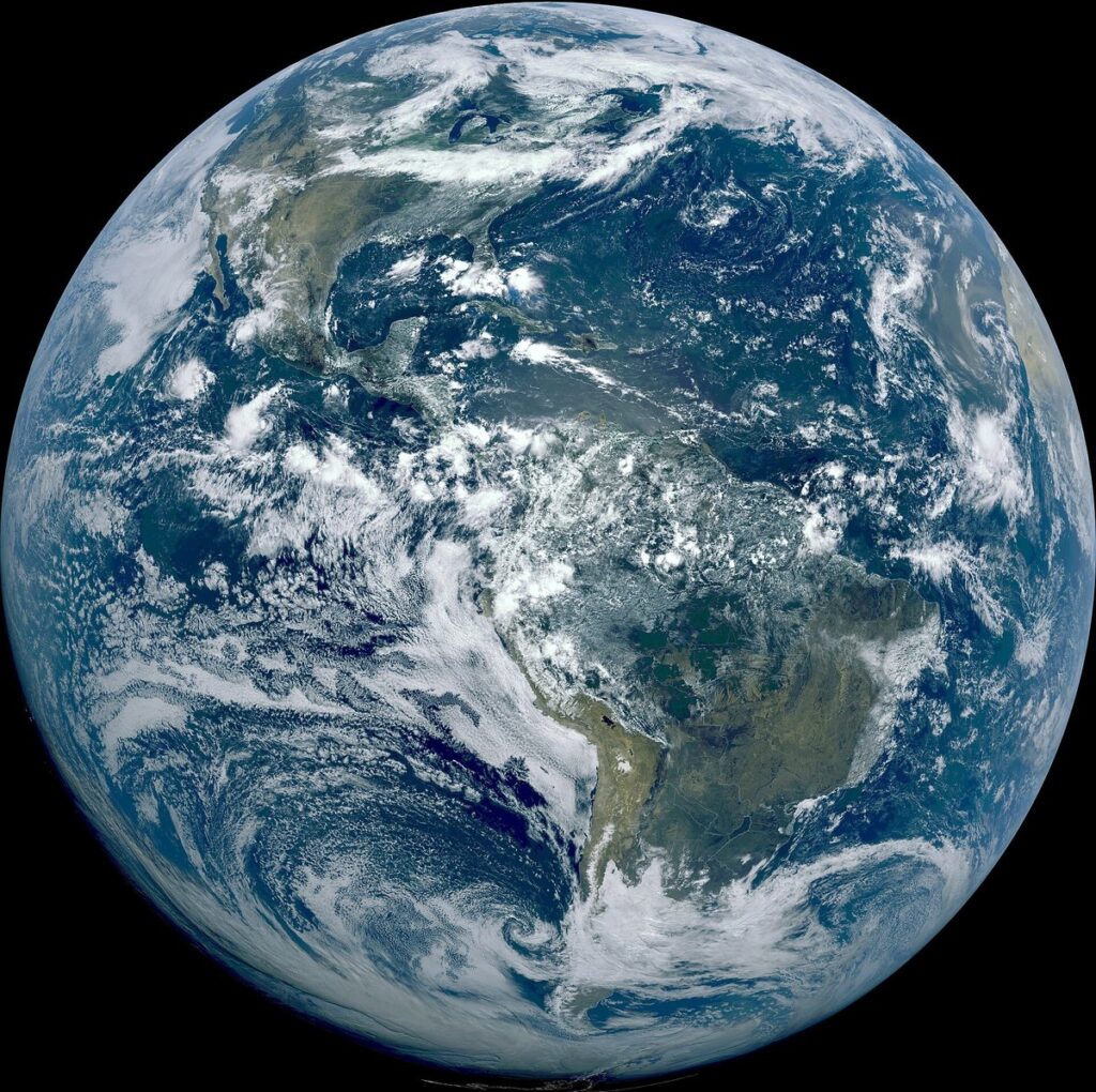 True-color image of the Americas from the GOES-16 weather satellite, showing cloud systems swirling across the globe